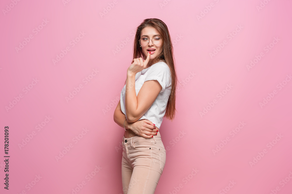Pretty young sexy fashion sensual woman posing on pink background dressed in hipster style jeans Pretty young sexy fashion sensual woman posing on pink background dressed in hipster style jeans
