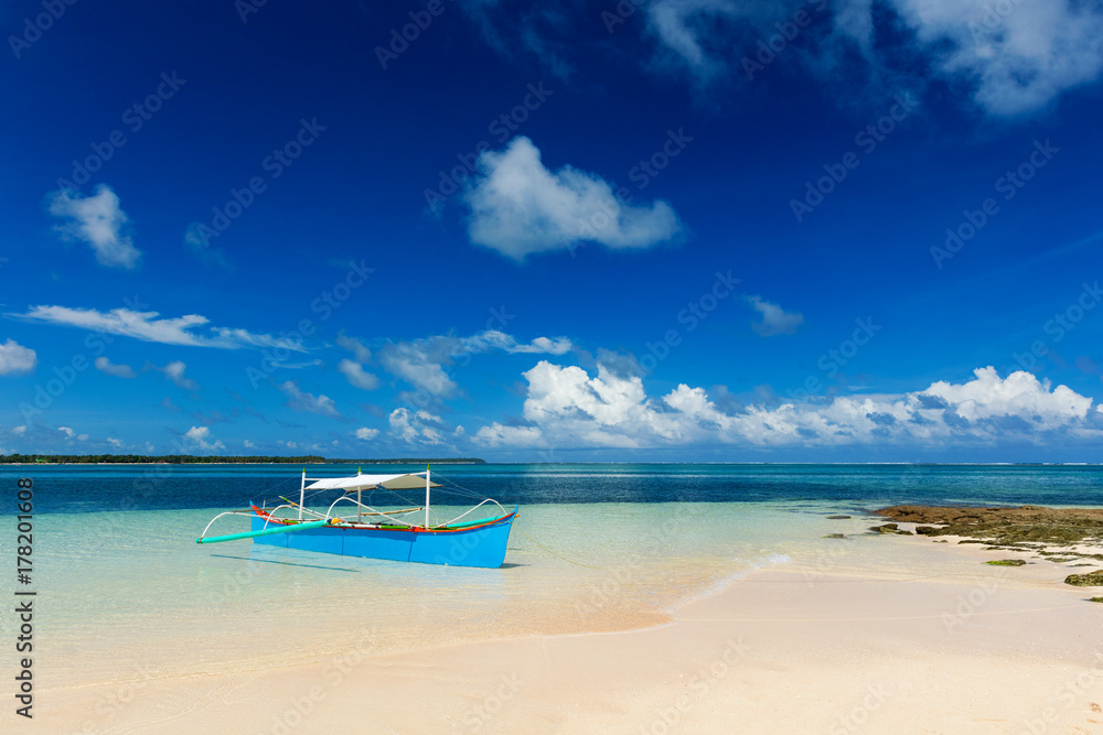 Traditional fishing boat on pristine beach