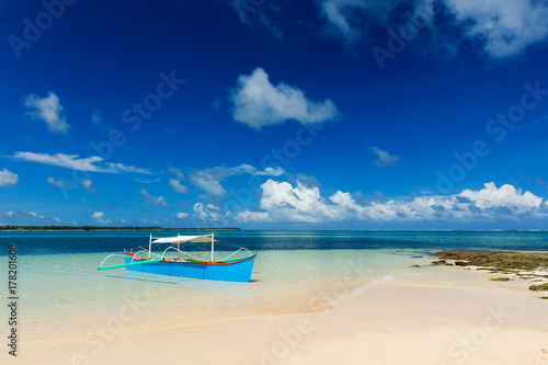 Traditional fishing boat on pristine beach © Zstock