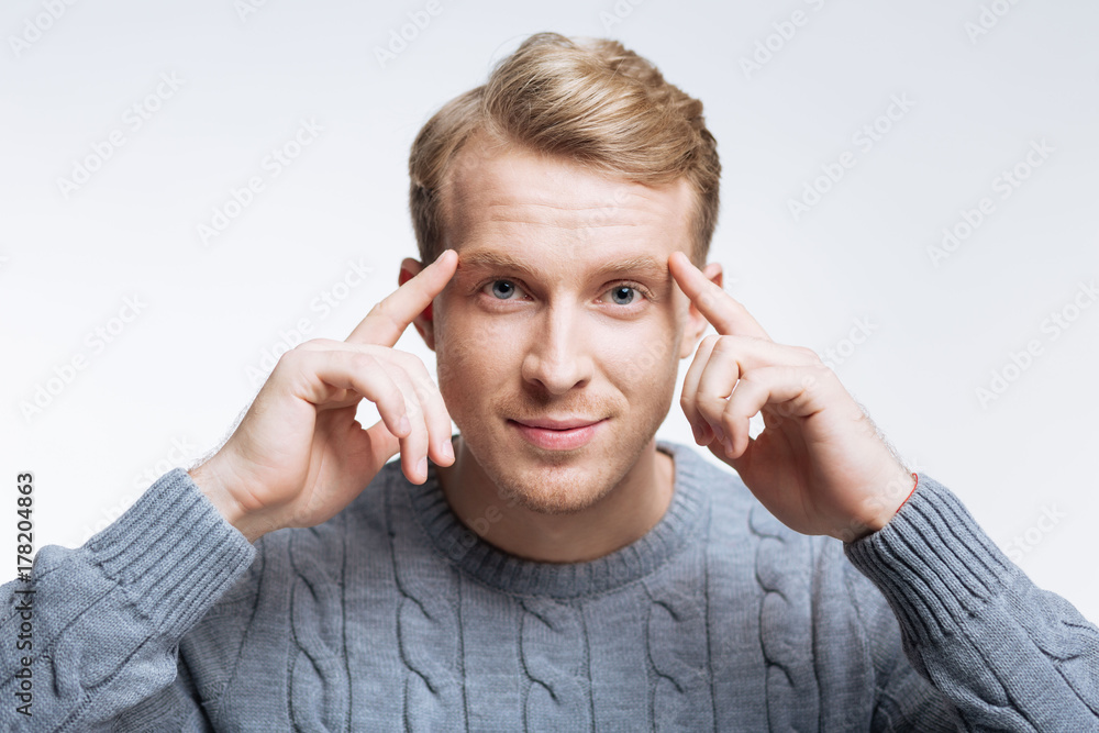 Handsome fair-haired man thinking hard Handsome fair-haired man thinking hard