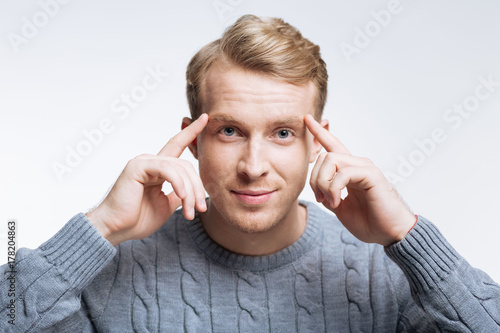 Handsome fair-haired man thinking hard
