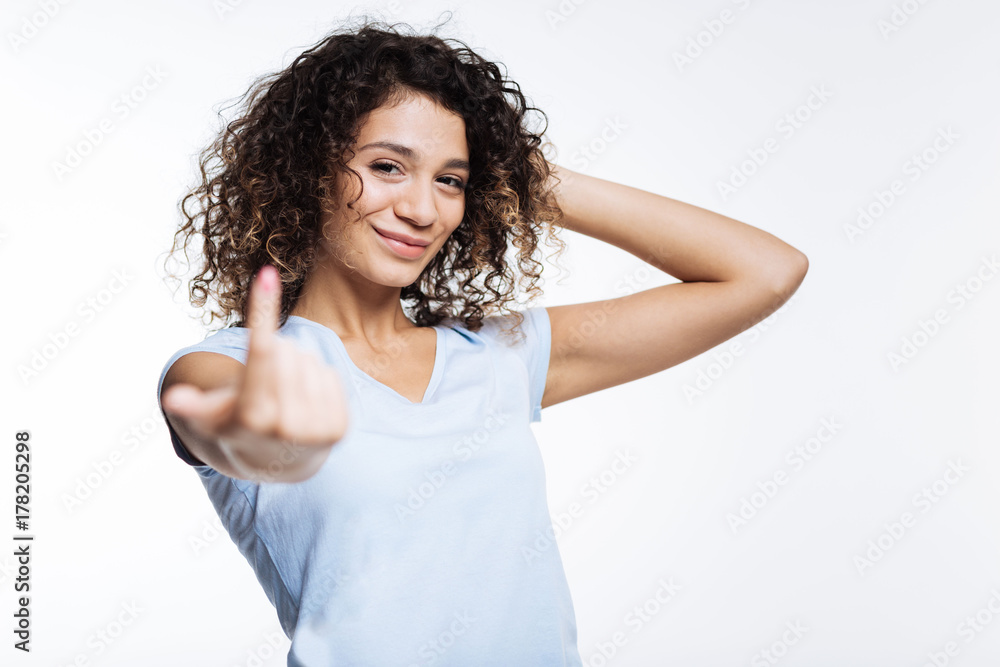Beautiful curly woman beckoning someone with a finger Beautiful curly woman beckoning someone with a finger
