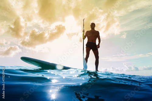 Canvas Print Stand up paddle board man paddleboarding at sunset