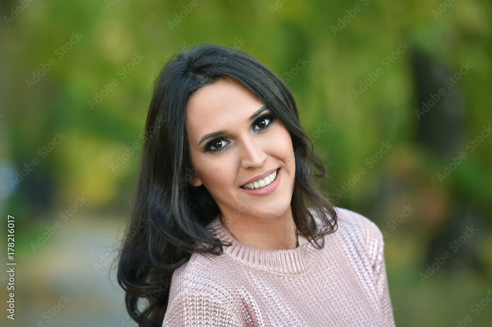 young fashion woman portrait in a park in autumn young fashion woman portrait in a park in autumn