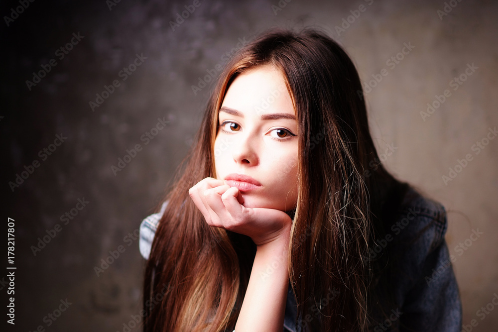 Portrait of young pensive bright beautiful European girls in the denim jacket Portrait of young pensive bright beautiful European girls in the denim jacket
