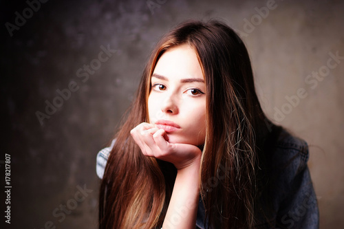 Portrait of young pensive bright beautiful European girls in the denim jacket