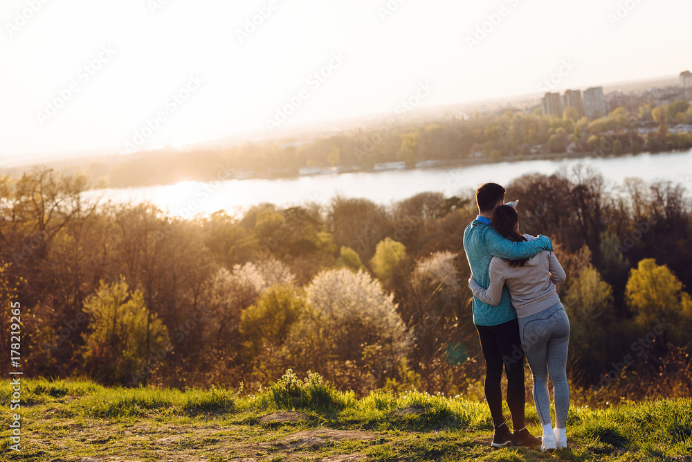 Happy young sporty couple sharing romantic moments Happy young sporty couple sharing romantic moments