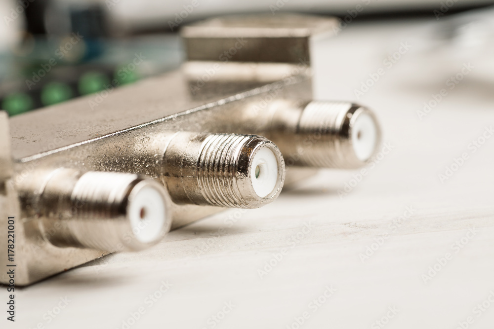 Tv cable splitter on a white table in repair shop, macro shot