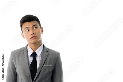 Portrait of a business man thinking with suit. Isolated on white background with copy space