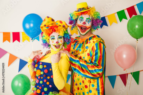 Two cheerful clowns. Birthday for children. Bright clown and clowness.