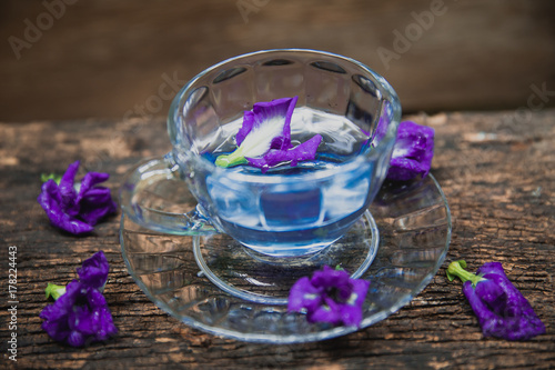 Violet flower Asian pigeonwings or Butterfly Pea Heabal hot drinking tea refresh Thai herb drink on wood background