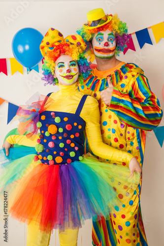 Two cheerful clowns. Birthday for children. Bright clown and clowness.