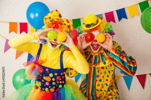 Two cheerful clowns. Birthday for children. Bright clown and clowness.