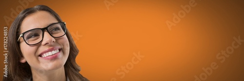 Woman looking up with orange background and glasses