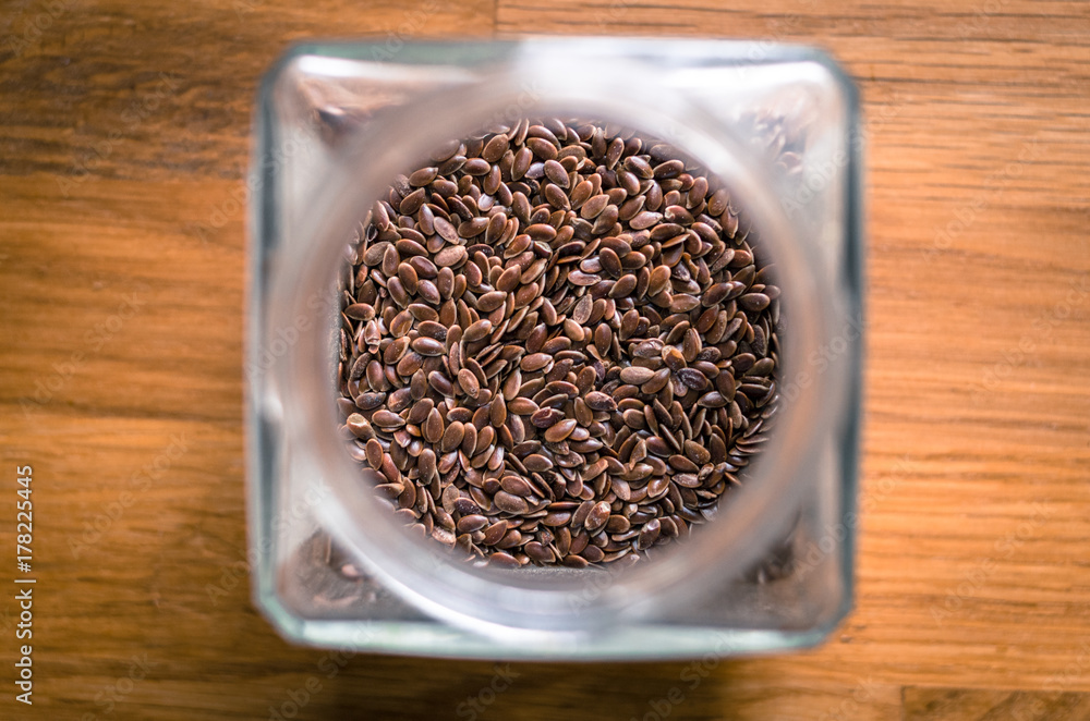 Top View on Glass jar with spices on the old wooden table Top View on Glass jar with spices on the old wooden table