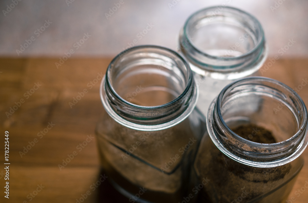 Three jar with spices on the natural wooden table Three jar with spices on the natural wooden table