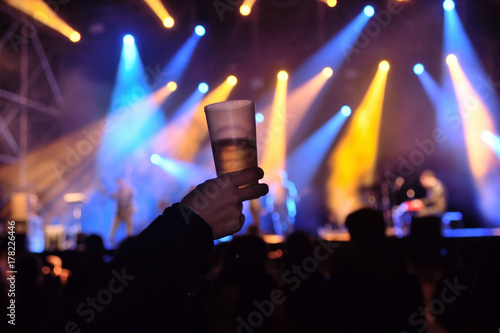 a glass of alcohol at a concert of live music