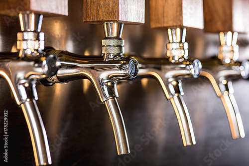 Beer taps in a pub photo