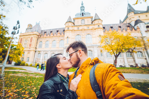 couple taking selfie in front of castle photo
