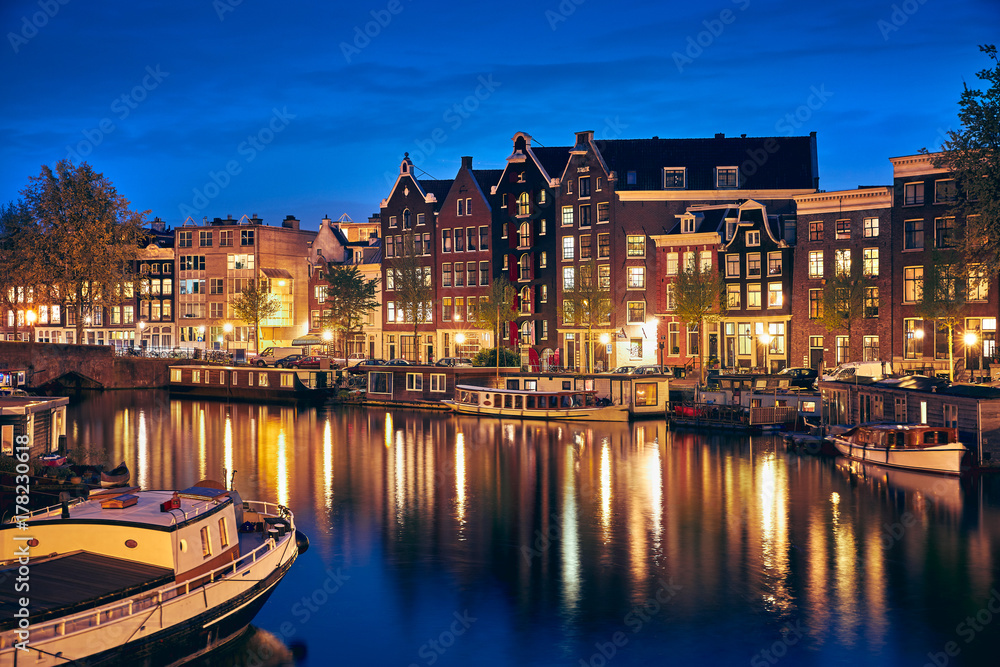 Evening town Amsterdam in Netherlands on bank river canal Amstel
