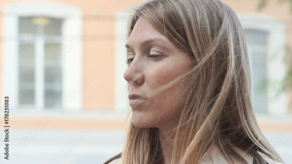 closeup portrait of deep in thought female face looking to the side. female face looking to the side when the wind waves her fair hair closeup portrait of deep in thought female face looking to the side. female face looking to the side when the wind waves her fair hair