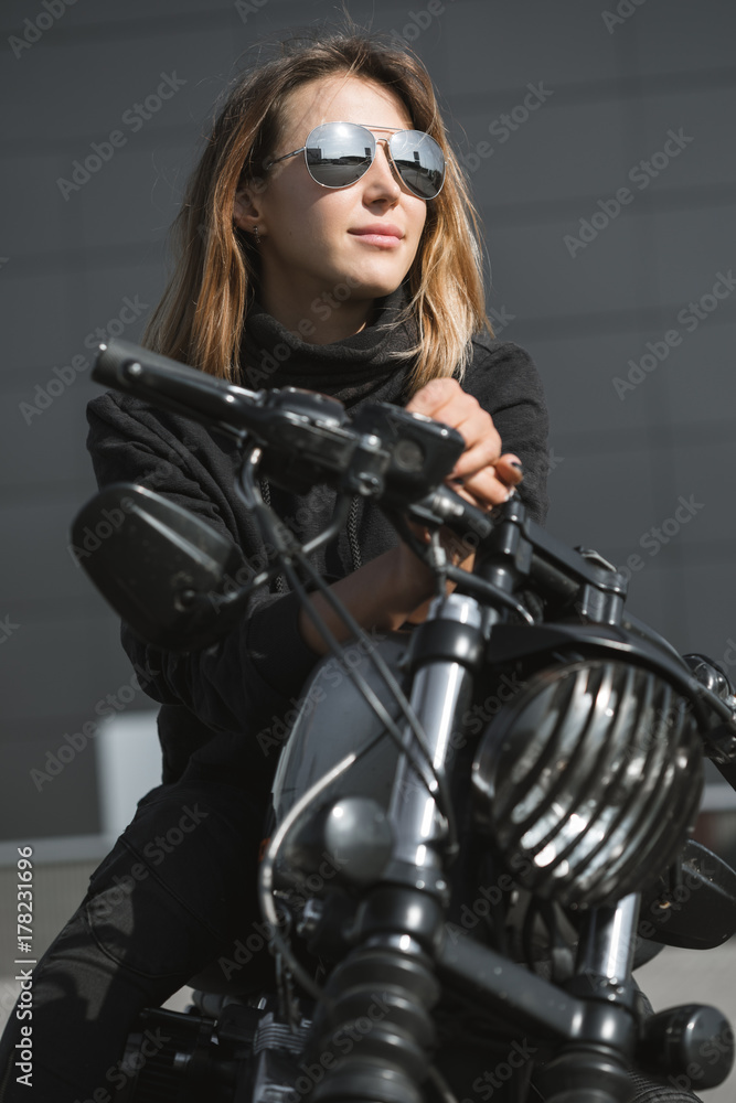biker woman sitting on motorcycle