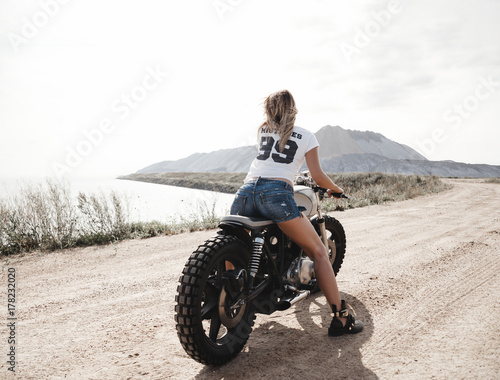 Canvas Print Sexy girl biker and cafe racer motorcycle