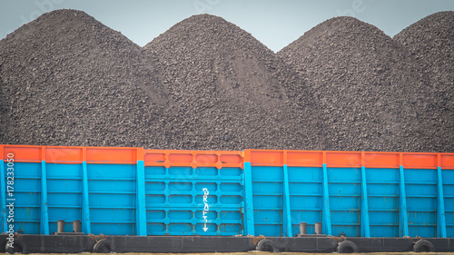 barge full loaded with black coal ready to transported through the river photo