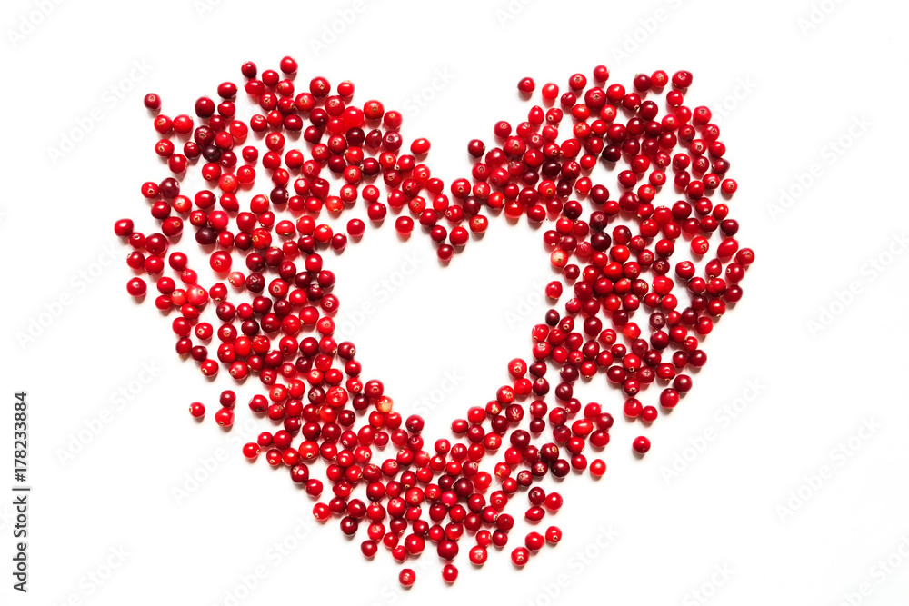 Heart from cranberries on a white background isolate top view of a flat with copy space