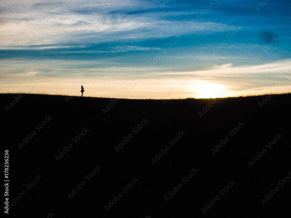 Silhouette light of the little girl on the top of the hill in trekking Mon Jong mountain, Chiangmai, Thailand.