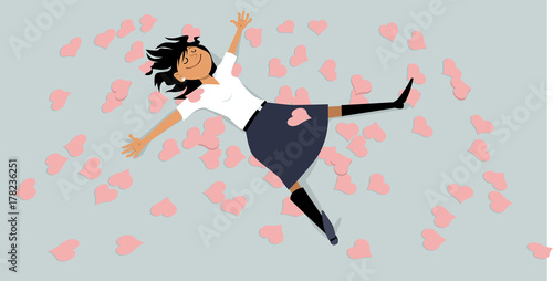 Happy girl lying on a floor, covered with hearts, EPS 8 vector illustration