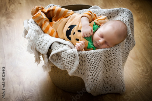 Funny baby in a pumpkin costume