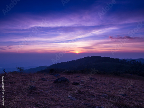 The hiding sun behind the mountain with colorful sky in Mon Jong, Chiangmai, Thailand. © yosanon