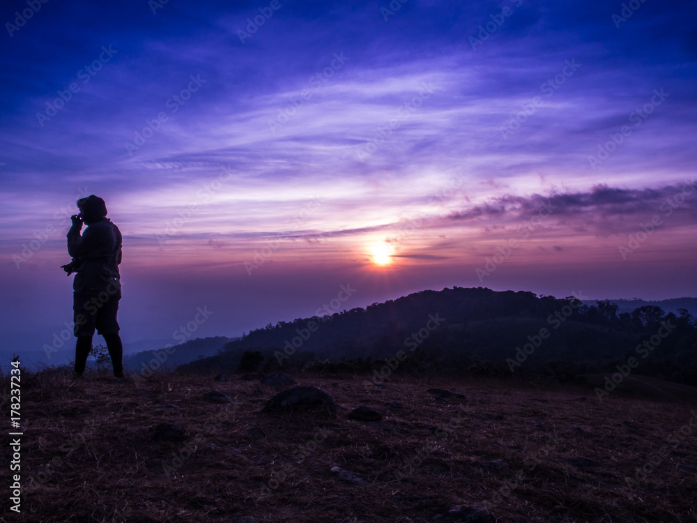 The traveler on the Mon Jong mountain with the sun rising.