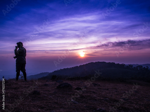 The traveler on the Mon Jong mountain with the sun rising.