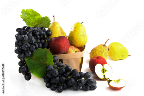autumnal fruit in basket isolated on white background