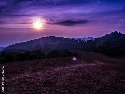 Traveler is trekking on Mon Jong mountain under the gradient sky sun rises in the morning, Chiangmai, Thailand.