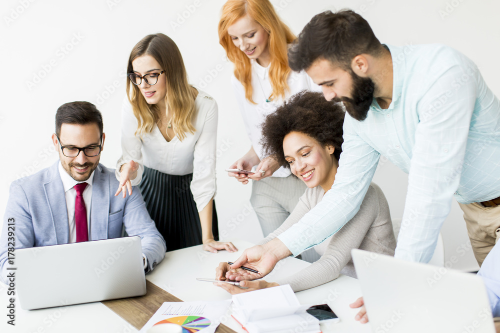 Group of businessmen and businesswomen working together in office. Group of businessmen and businesswomen working together in office.