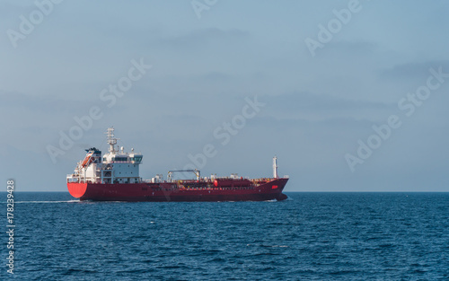 Side view of cargo vessel sailing in open sea