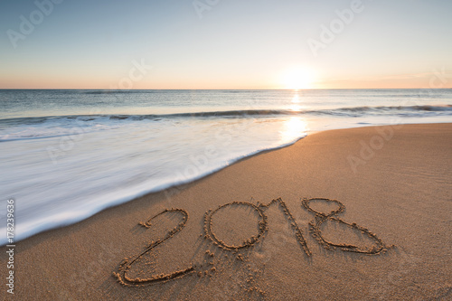 2018 message written in the sand on the beach