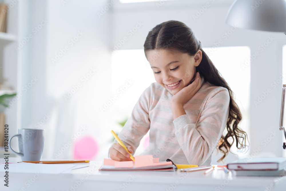 Delighted positive girl sitting in her room Delighted positive girl sitting in her room