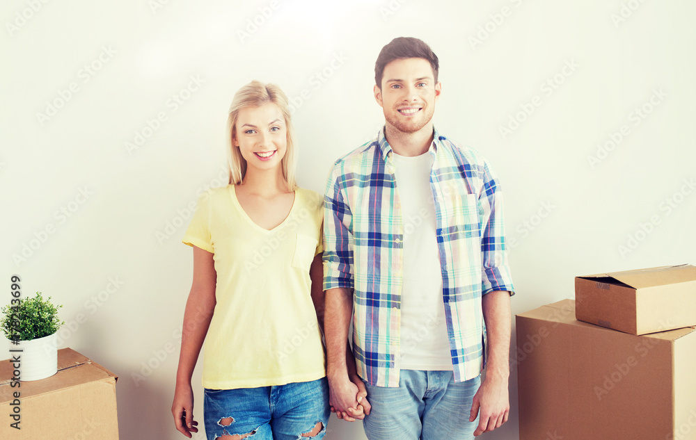 smiling couple with big boxes moving to new home smiling couple with big boxes moving to new home