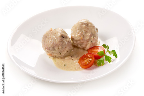 Meatballs with creamy sauce, isolated on white background