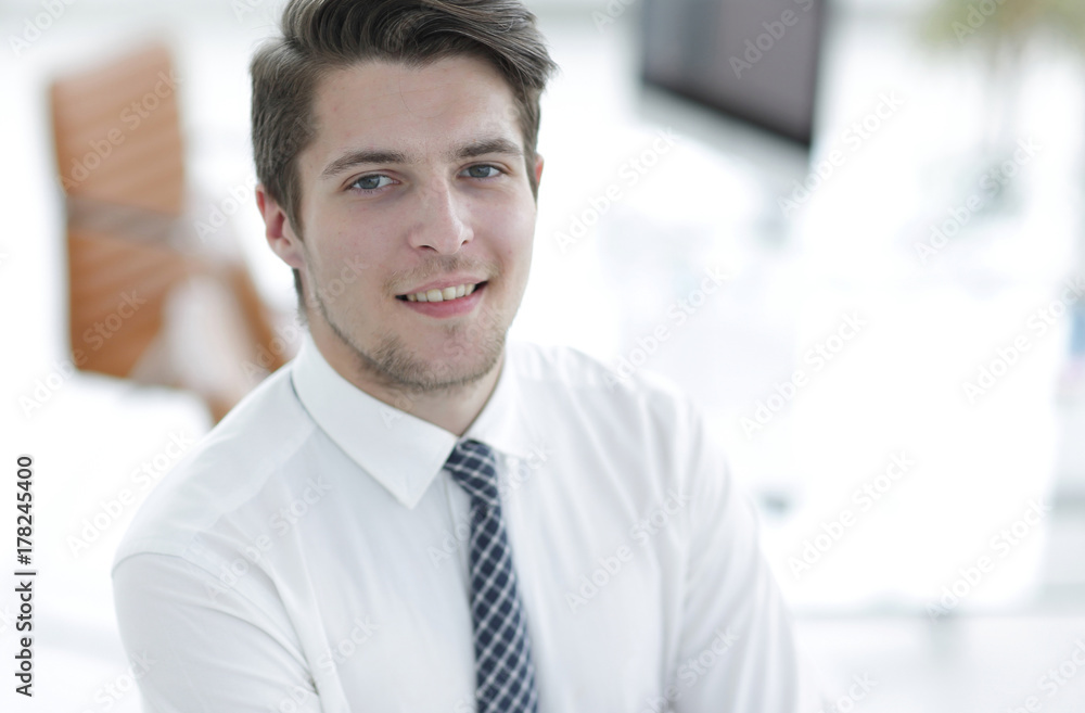 confident young businessman on background of office confident young businessman on background of office