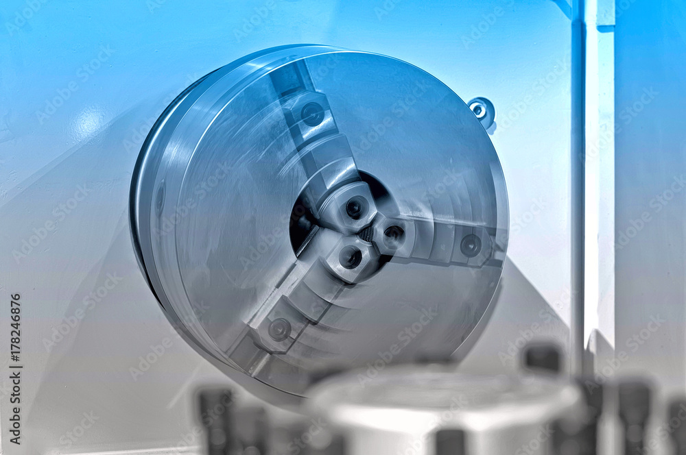 Rotating spindle of the industrial lathe. Blue toning Rotating spindle of the industrial lathe. Blue toning