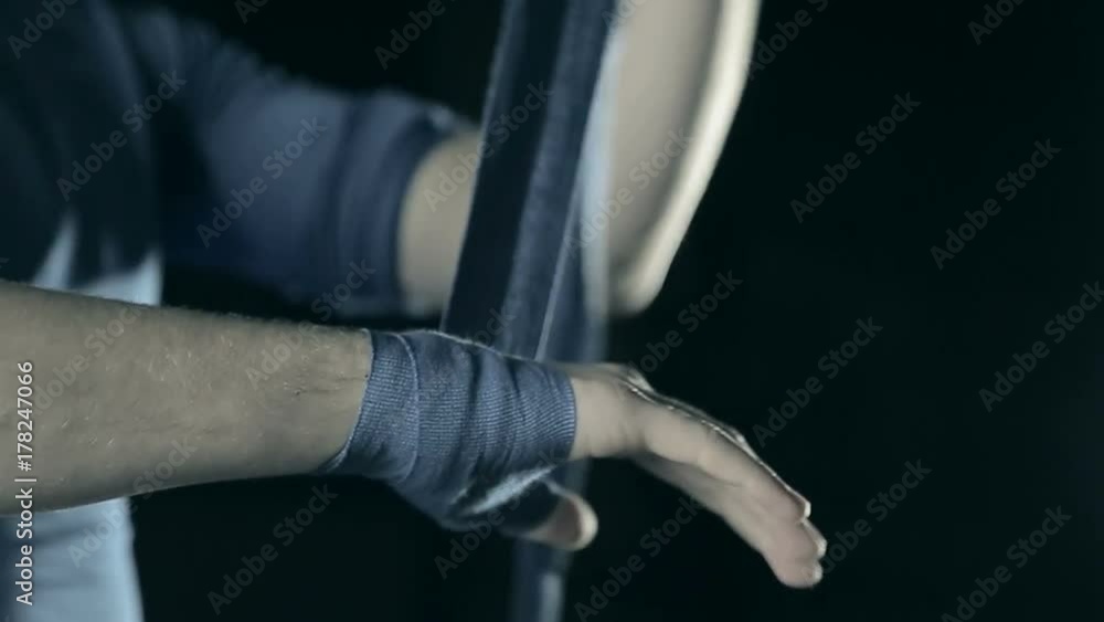 boxer wrapping bandages on his hand before fight boxer wrapping bandages on his hand before fight