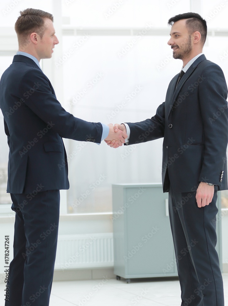 handshake financial partners in the corridor of the office handshake financial partners in the corridor of the office