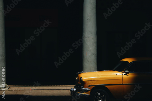 Shadow hides yellow retro car © IVASHstudio