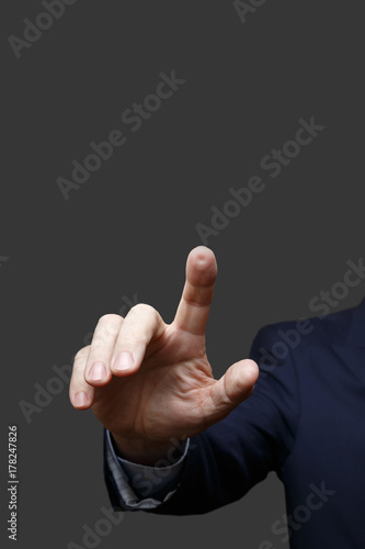 The hand presses an imaginary button. Isolated on a gray background