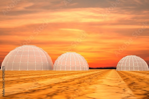 Desert spheric habitats under sunset sky